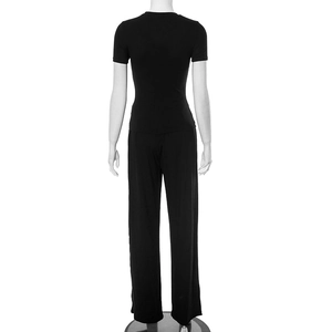 Back view of a black casual two-piece lounge set with short sleeve top and wide leg pants
