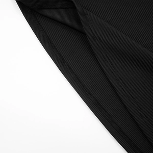 Detailed macro view of the black ribbed fabric texture and fine stitching on the long dress