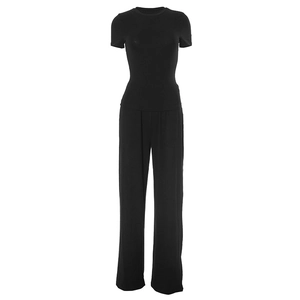 Detail of soft black knit fabric on wide-leg trousers and crew neck short sleeve lounge set