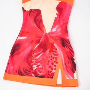 Close-up of red floral print dress featuring sexy side slit and orange edge detailing