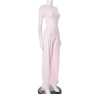 Detail view of light pink two-piece set featuring slim fit T-shirt and high waist wide-leg pants