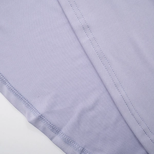 Detail shot of light purple knit dress with high-quality flatlock stitching and seams