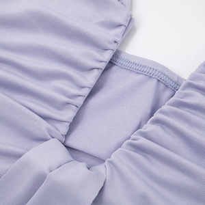 Close-up of light purple ribbed dress showing elegant ruching and fine stitching details