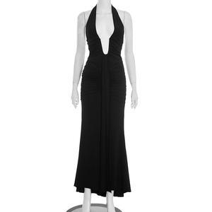 Detail of elegant black halter neck maxi dress with ruched waist and deep V-neckline