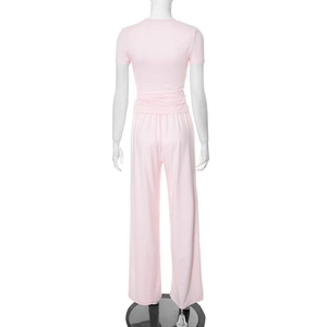 Rear view of casual pink long-sleeve T-shirt and wide-leg trousers set for women