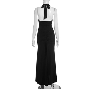 Back view of black halter dress with large bow tie and gathered ruching details