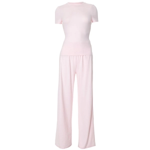 Detail of light pink casual lounge set featuring ribbed knit fabric and wide leg trousers