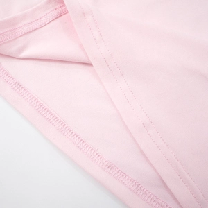 Macro shot of precise double-needle stitching and pink knitted fabric texture details