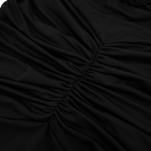 Detailed close-up of elegant black fabric with intricate gathered pleats and soft sheen