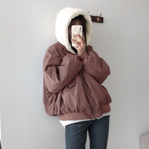 Detail of oversized winter hoodie featuring a large faux fur hood and warm fleece lining
