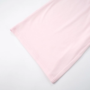 Detailed close-up of double-needle stitching on the hem of pink long-sleeved loungewear set