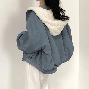 Detail view of oversized hooded jacket with soft plush lining and side zip detail
