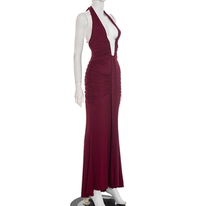 Detail of burgundy halter neck maxi dress featuring side ruched pleated texture