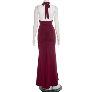 Detailed back view of burgundy halter neck dress featuring ruched pleats and backless design