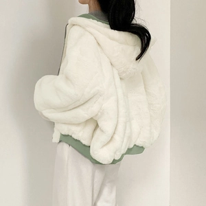 Detail of white faux rabbit fur jacket with hooded design and sage green ribbed hem