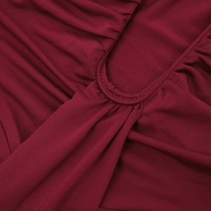 Macro detail of wine red ruched fabric with subtle gloss and premium stitching