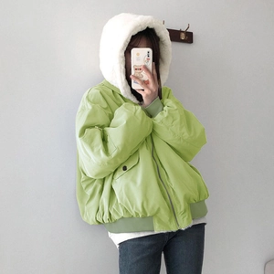 Detail view of light green hooded bomber jacket featuring plush white faux fur lining
