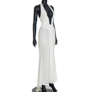 Detail of elegant white halter neck maxi dress with deep V-neck and ruched side styling