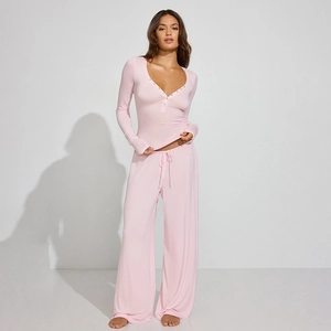 Women's pink two-piece lounge set with long sleeve button top and drawstring pants