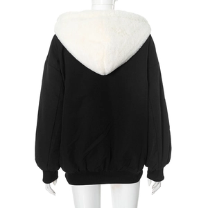 Detail view of the back of a black hooded jacket with white faux fur lining on the hood