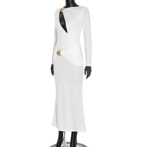 Detail of elegant white long sleeve dress showing metal ring buckles and shoulder cut-out