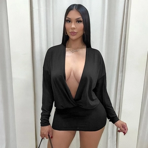 Detail of a black deep V-neck bodycon dress with batwing sleeves and luxury gold necklace