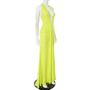 Detail of neon green halter maxi dress featuring pleated waist and deep V-neckline