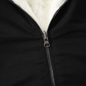 Detail shot of heavy-duty silver metal zipper with thick white faux fur lining texture