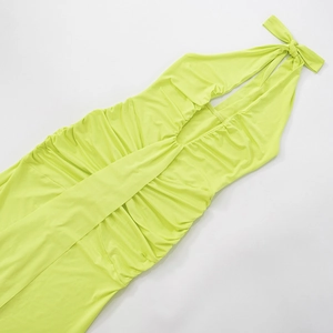 Flat lay of neon yellow halter neck maxi dress with pleated details and open back