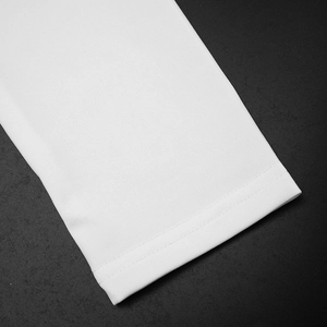Close-up of white dress cuff featuring detailed double-needle stitching and knit texture