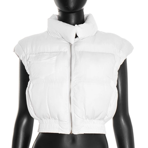 Detail of white cropped puffer vest with stand collar, metal zipper and pocket flaps