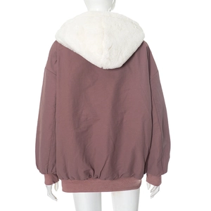 Detail view of mauve zip-up hoodie featuring a thick white faux fur hood and elastic hem