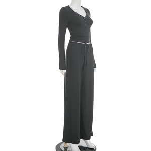 Detail of black two-piece lounge set with V-neck button top and drawstring pants