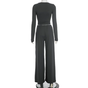 Rear view of black long sleeve crop top and high waist wide leg trousers on a mannequin