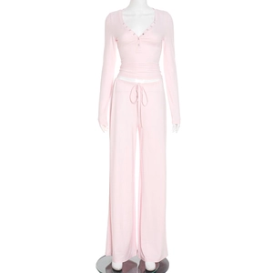 Detail of light pink casual set featuring V-neck buttoned top and drawstring trousers