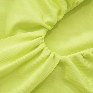 Macro detail of fluorescent green ribbed knit fabric featuring elegant ruched texture design