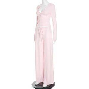 Detail of light pink loungewear set with button-up long sleeve top and drawstring pants