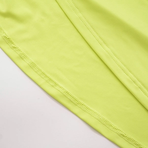 Macro view of neon green athletic fabric showing durable twin-needle coverstitch hems