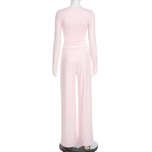 Rear view of pink long sleeve top and wide leg pants set on mannequin with draped fabric