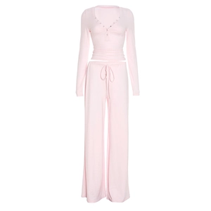 Detail of light pink lounge set featuring V-neck buttons and drawstring waistband