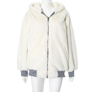 Detail of a plush cream hooded jacket with grey ribbed cuffs and contrast zipper piping
