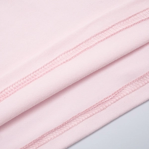 Detail of double-needle stitching and smooth pink knit fabric texture on the hemline