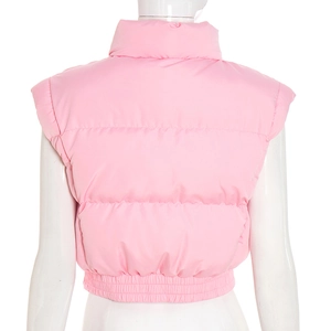 Macro shot of pink quilted puffer vest featuring high stand collar and elastic hem detail