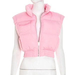 Close-up of bright pink quilted puffer vest featuring elastic hem and zip-up collar