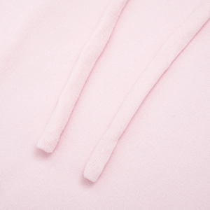 Detail of pink hoodie featuring soft knit fabric and matching drawstring texture