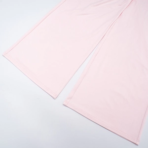 Close-up of light pink wide-leg trousers with high-density knit fabric and double stitching