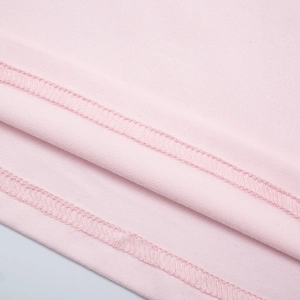 Detail of pink loungewear hem showing high-quality double-needle stitching and fabric