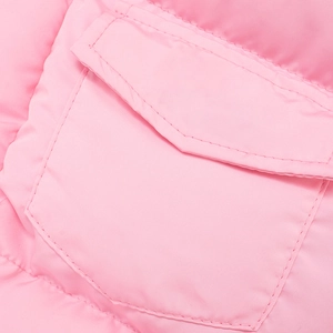 Close-up of pink quilted puffer vest featuring a functional flap pocket and double stitching