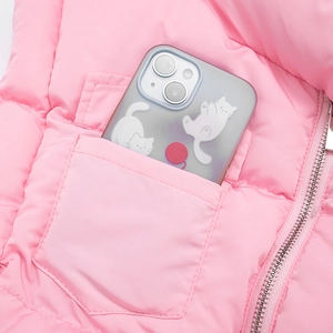 Detail shot of the side pocket and metal zipper on a pink quilted puffer vest