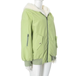 Detail view of light green hooded jacket with thick white sherpa lining and utility pocket